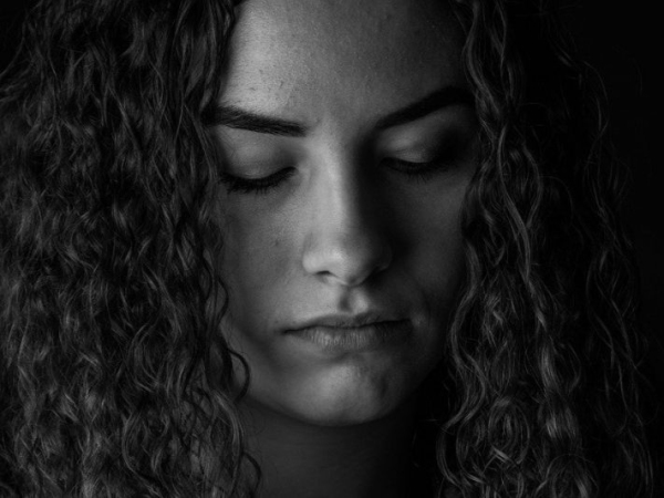 woman looking down, representing the #metoo movement