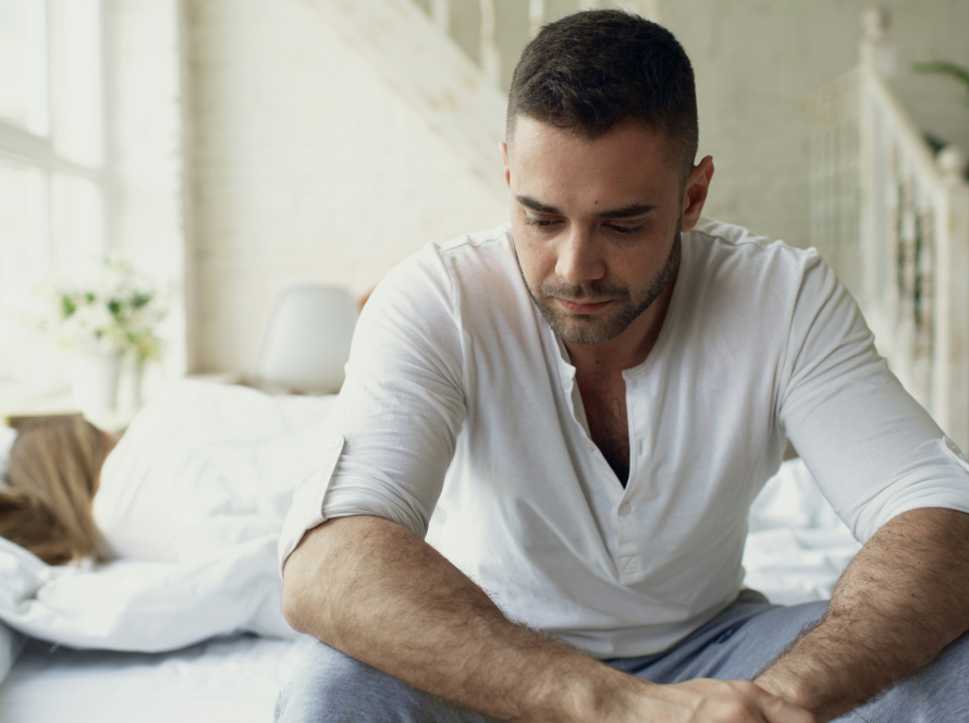 the man sitting on a bed might benefit from a trauma-informed therapist