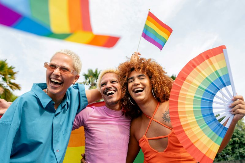 Three friends in the LGBTQIA community celebrate pride and are confident in their identities after receiving LGBTQIA specialized therapy