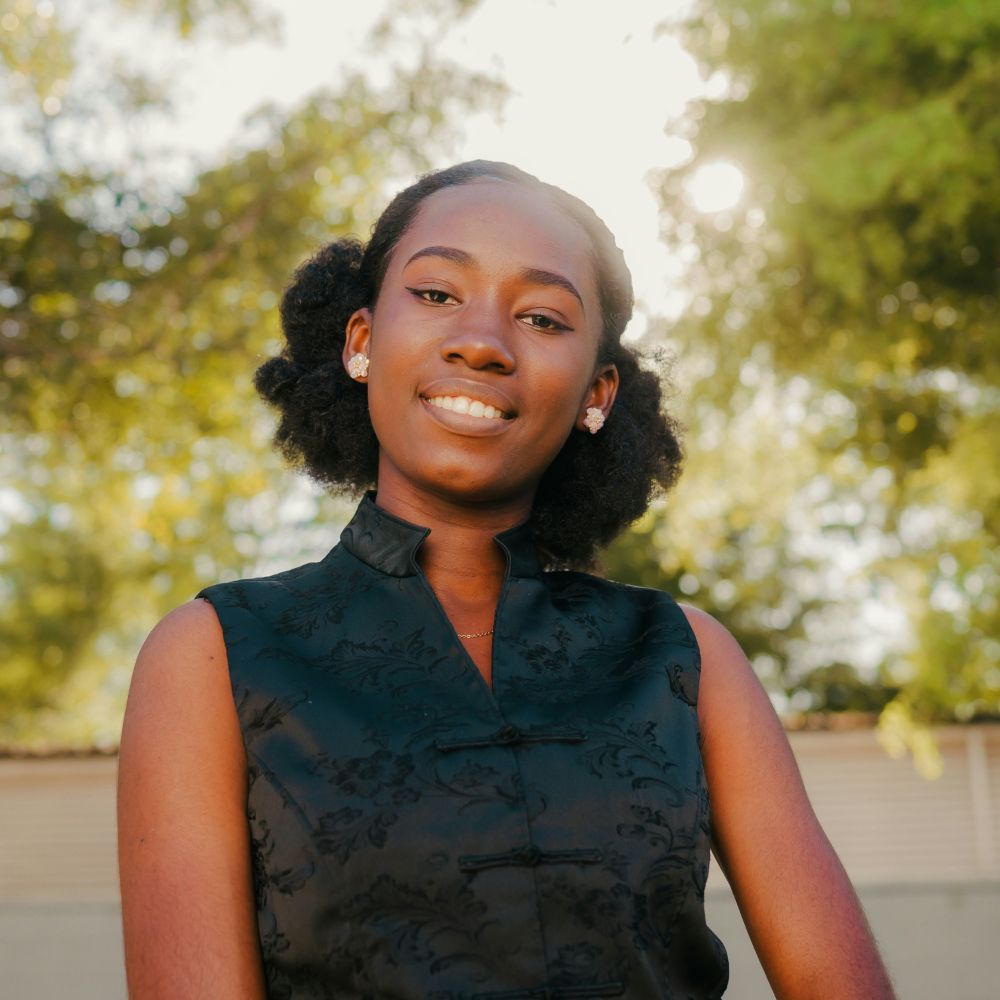 Older African American youth smiles outdoors after individual therapy session